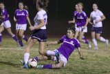 Lemoore's Lisette Camacho keeps her eye on the ball during Friday night's soccer match with Redwood High School, which the Tigers lost in overtime.
